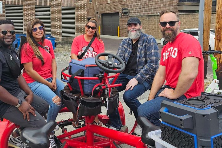 a group of people riding on the back of a motorcycle