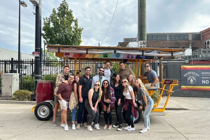 a group of people standing in front of a sign