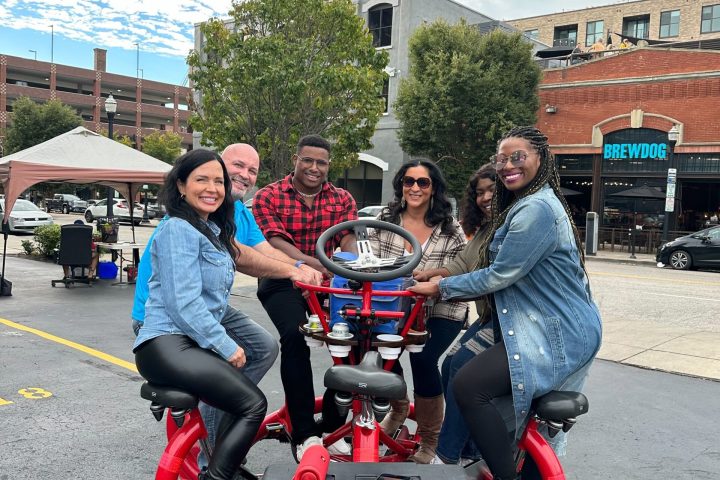 a group of people riding on the back of a motorcycle