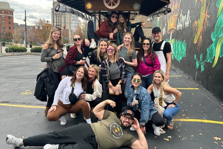 a group of people sitting on the side of a road