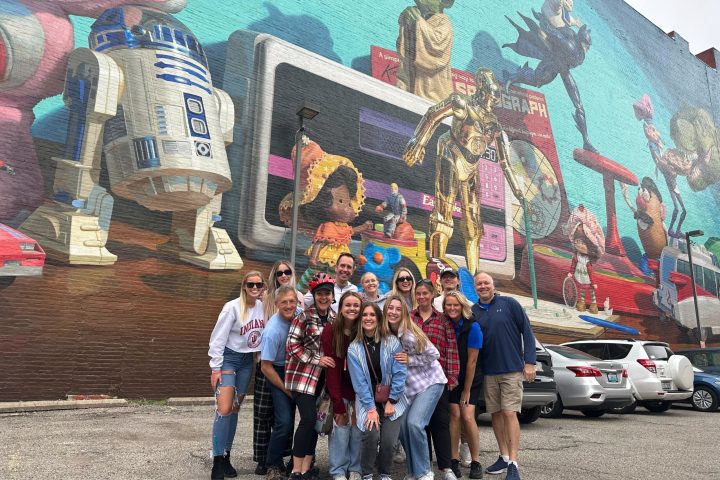 a group of people standing in front of a crowd posing for the camera