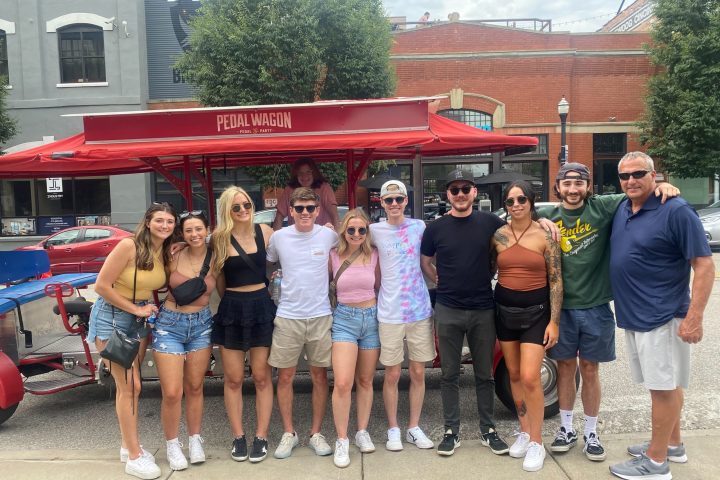 Robb Akey et al. standing in front of a crowd posing for the camera