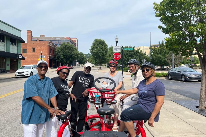 a group of people standing on a sidewalk