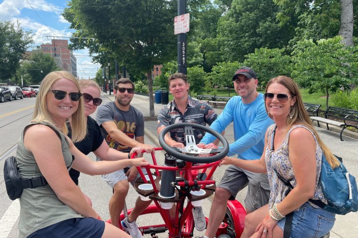 a group of people standing around a motorcycle
