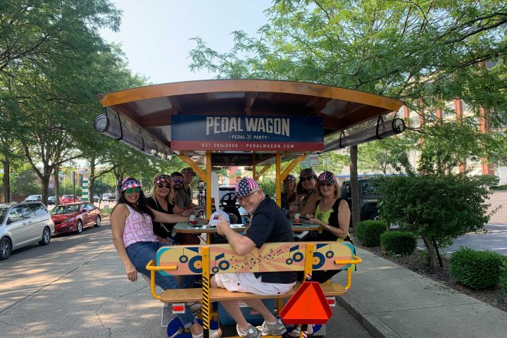 a group of people riding on the back of a motorcycle