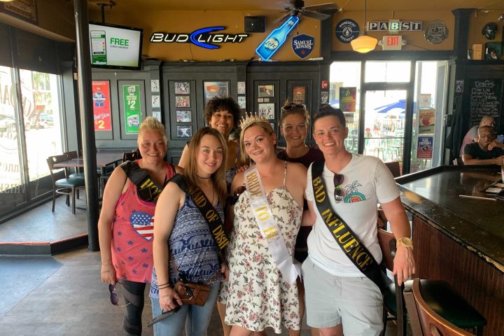 a group of people standing in front of a store