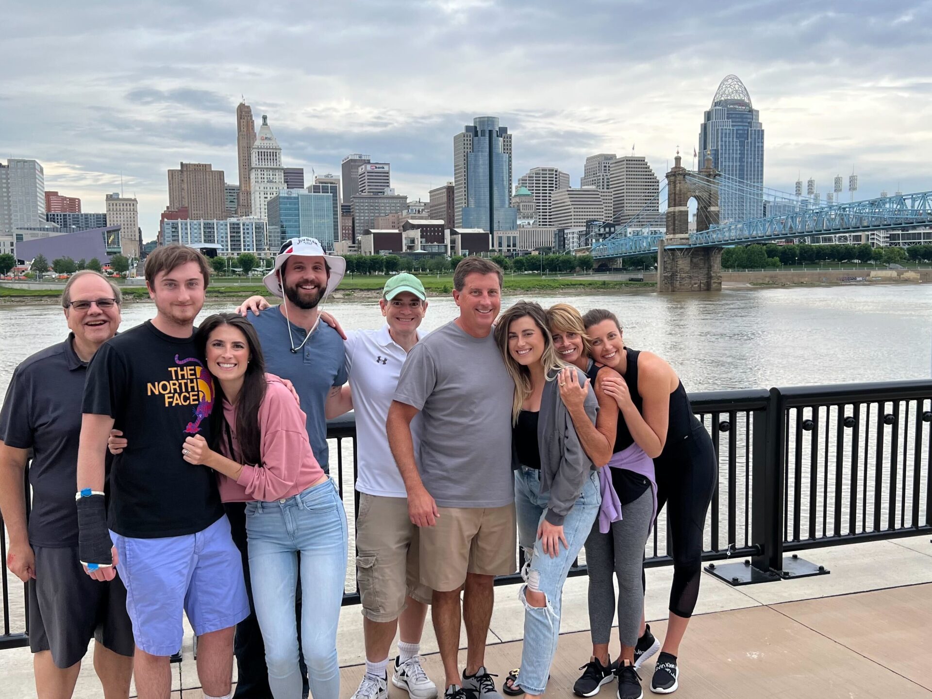 a group of people standing in front of a bridge