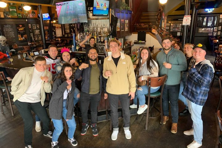 a group of people standing in front of a crowd posing for the camera