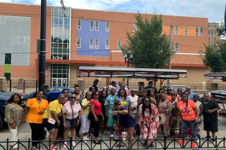 a group of people walking in front of a building