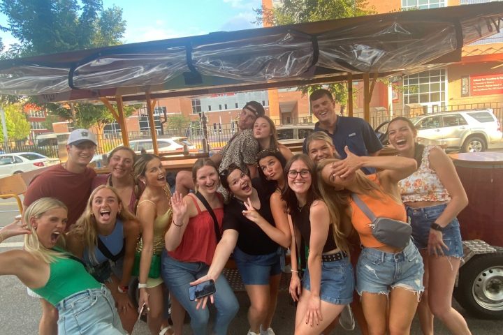a group of people standing in front of a crowd posing for the camera