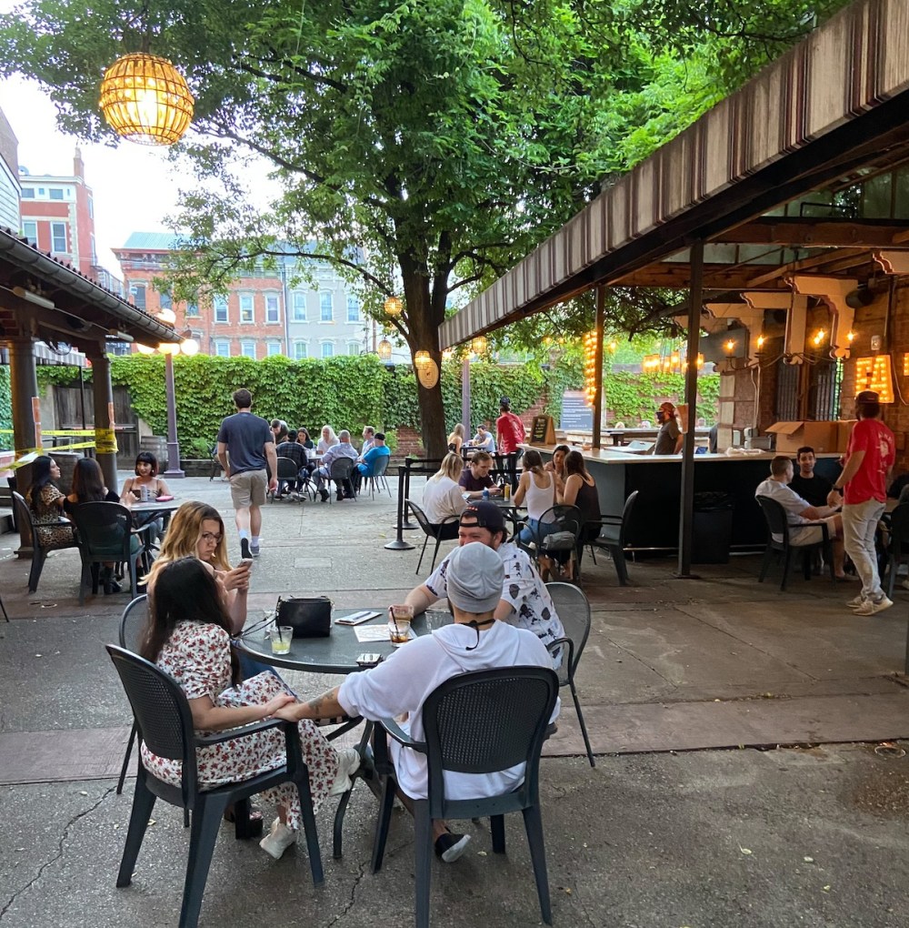 a group of people sitting at a table in front of a building