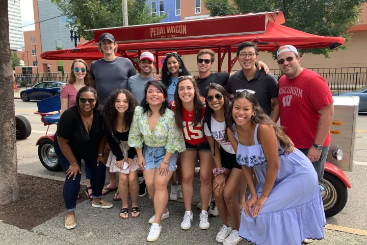 a group of people standing in front of a crowd posing for the camera