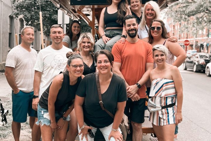 a group of people standing in front of a crowd posing for the camera