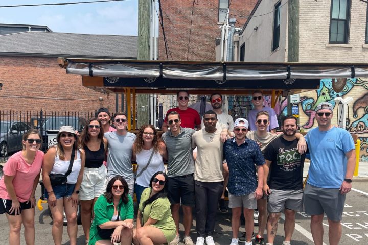 a group of people standing in front of a crowd posing for the camera