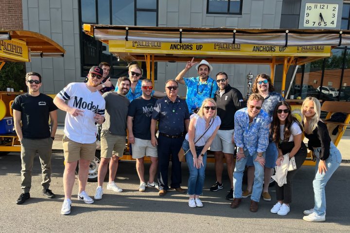 a group of people standing in front of a crowd posing for the camera