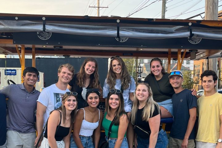 a group of people standing in front of a crowd posing for the camera