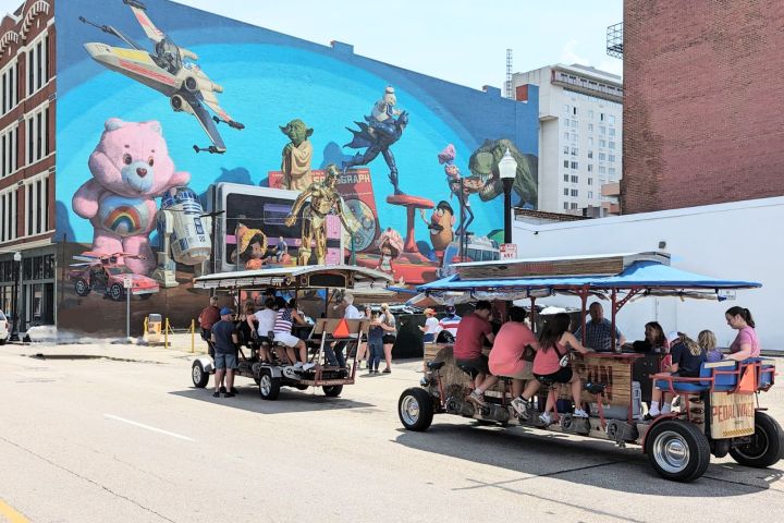 a group of people riding on the back of a truck